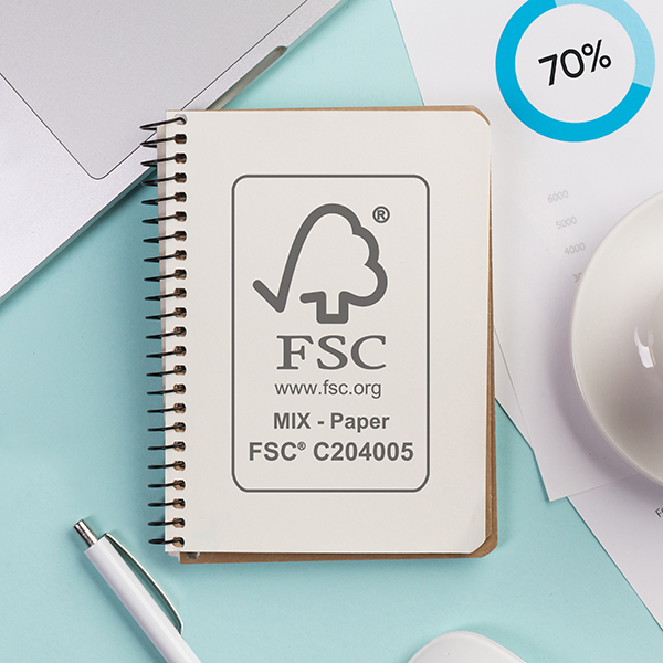 closed spiral notepad with laptop earphone pen mouse coffee cup budget plan blue desk fsc 600
